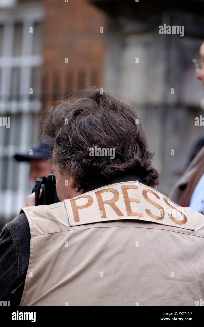 A Press Photographer, denoted by the word Press on his back. Stock Photo