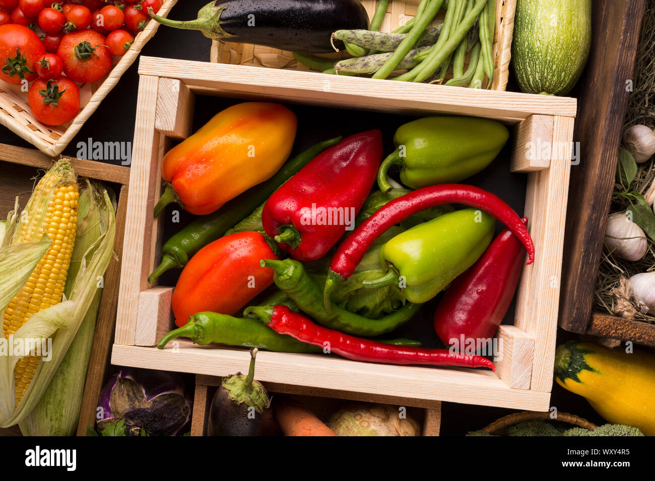 Different red green farm peppers in wooden box Stock Photo - Alamy