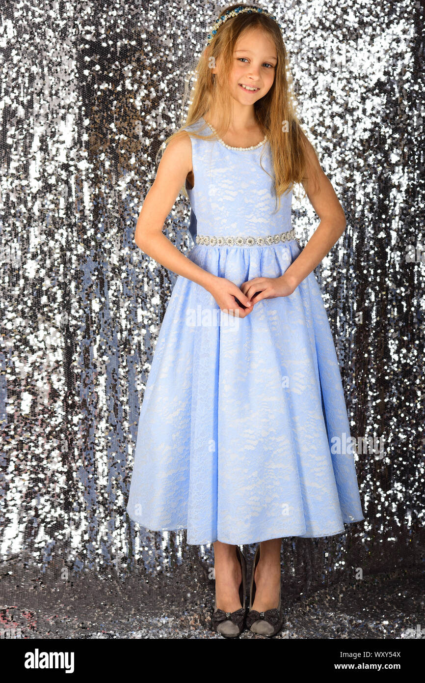 cute little girl in blue dress on silver background Stock Photo - Alamy