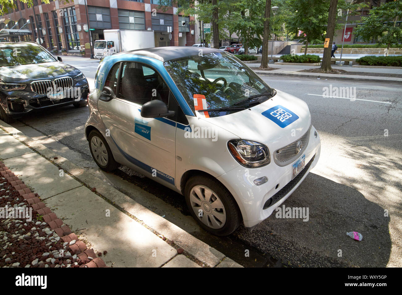car 2 go car rental scheme car with parking ticket under the wiper blade on window parked in cleaning zone in downtown chicago illinois united states Stock Photo