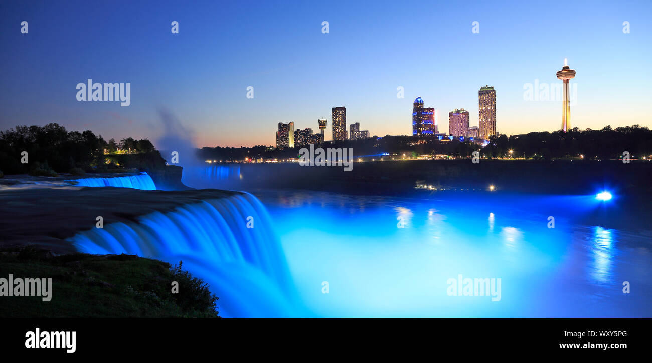 Niagara Falls at dusk including the skyline of the Canadian city of the background Stock Photo