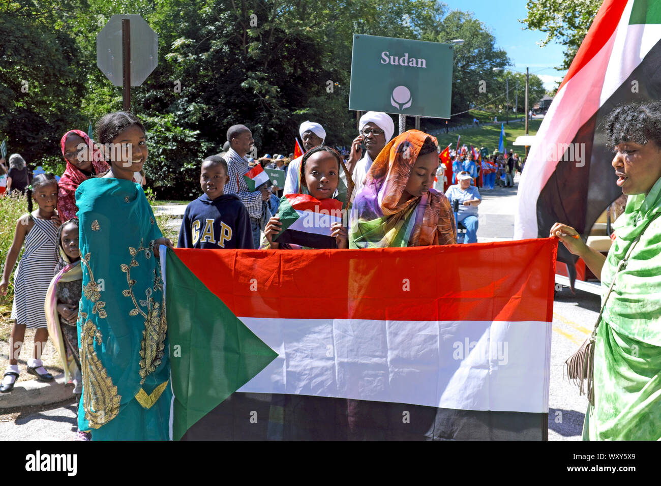 A group representing the Sudanese immigrant community of Cleveland, Ohio, USA hold the Sudan flag while dressed in traditional clothing. Stock Photo