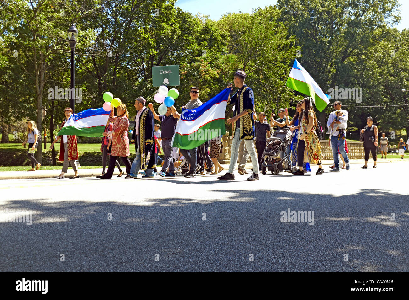 Participants in the 2019 One World Day celebration representing Uzbekistan wave their flag during the Cleveland, Ohio celebration on August 25, 2019 Stock Photo