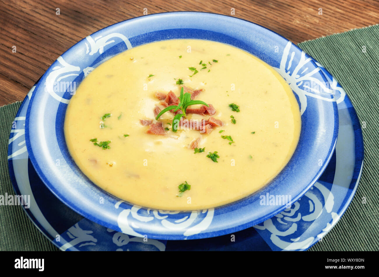 Yellow split pea cream soup with bacon and basil Stock Photo