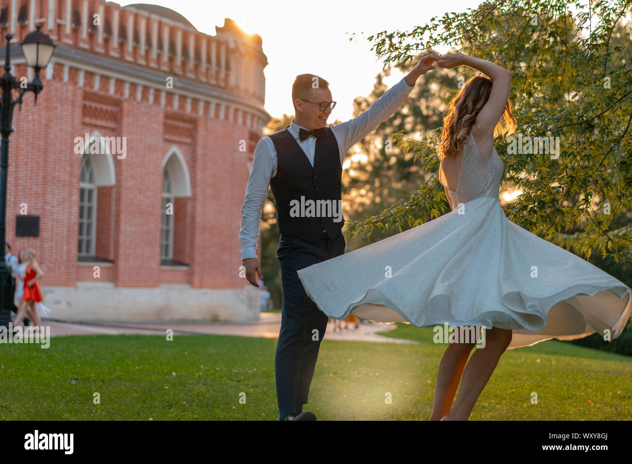 https://c8.alamy.com/comp/WXY8GJ/young-happy-groom-whirling-and-spinning-smiling-bride-in-a-curvy-wedding-dress-outdoors-at-summer-park-lovely-girl-bride-in-wedding-dress-WXY8GJ.jpg