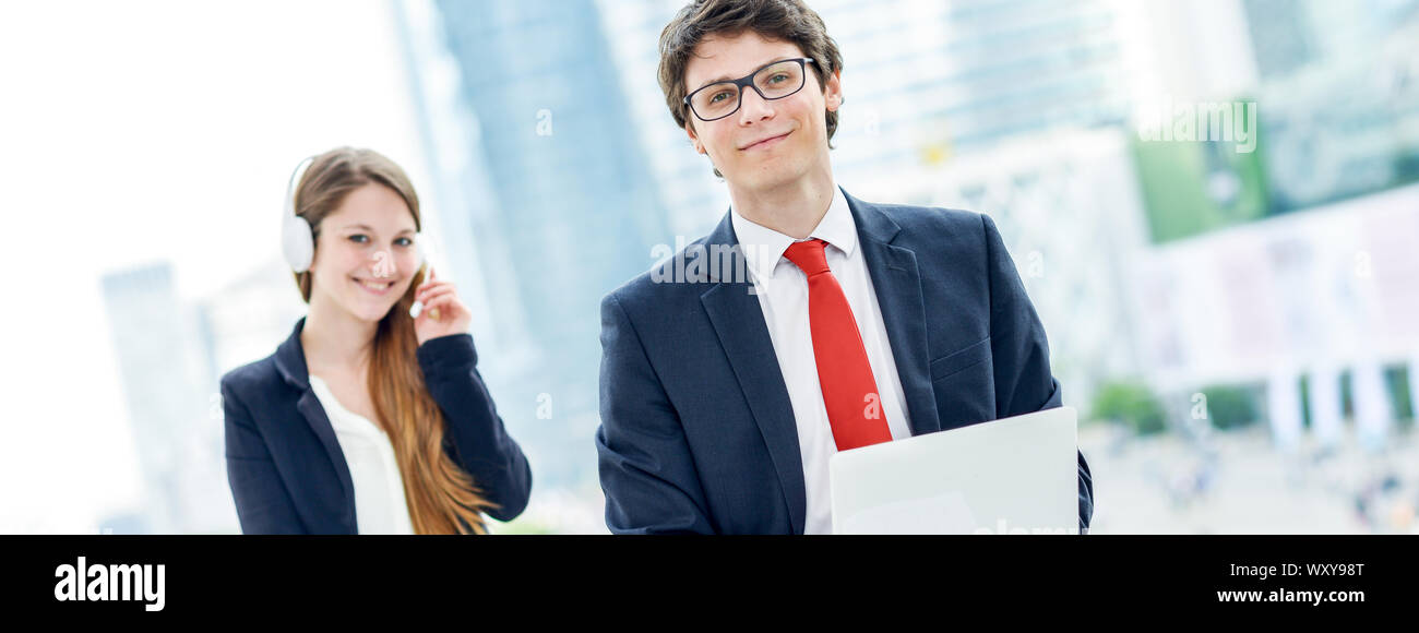 panoramic view on business junior leader with pretty blonde operator on background Stock Photo