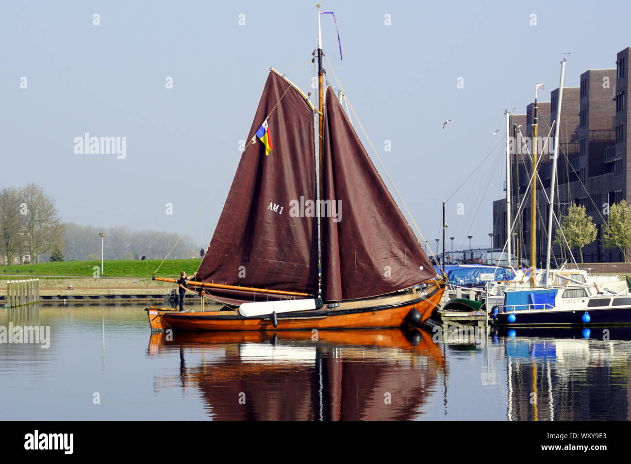 Almere, the Netherlands - March 29, 2019: Traditional wooden visser ship in the harbor of Almere Haven. Stock Photo