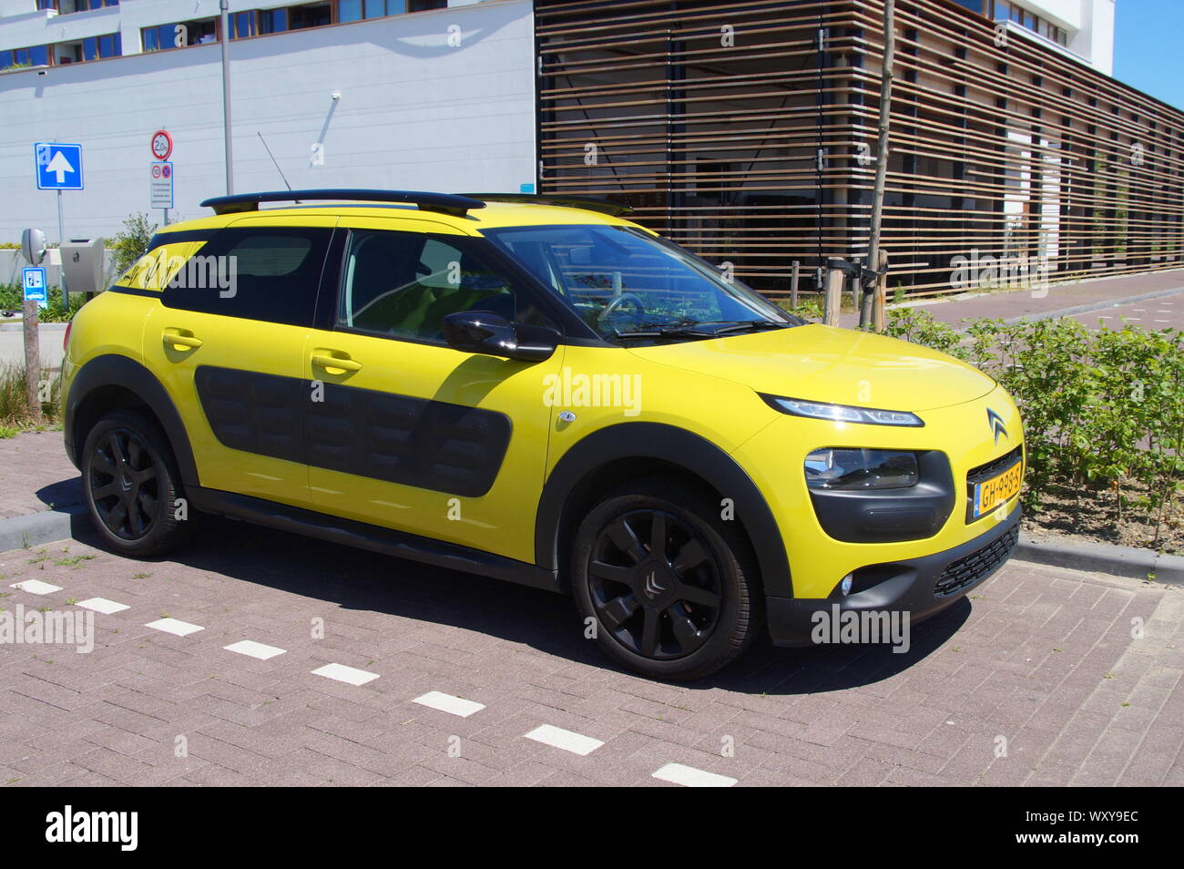Almere, The Netherlands - May 25, 2017: Yellow Citroën C4 Cactus parked in a public parking lot. Stock Photo