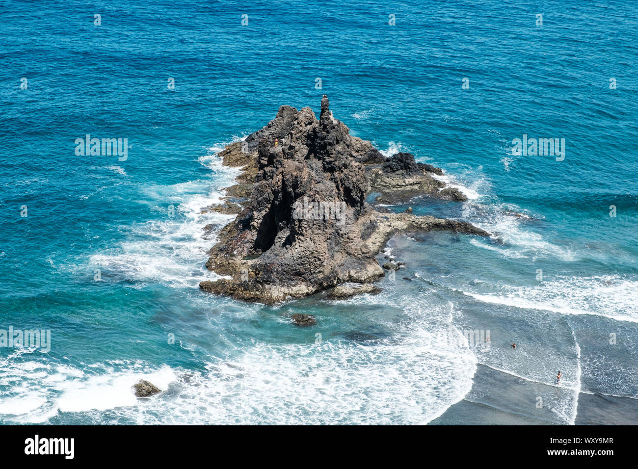 black rock in ocean waves near beach , aerial Stock Photo
