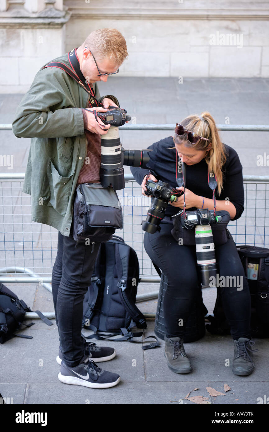 Photographers reviewing images they captured in front of the Supreme Court Stock Photo