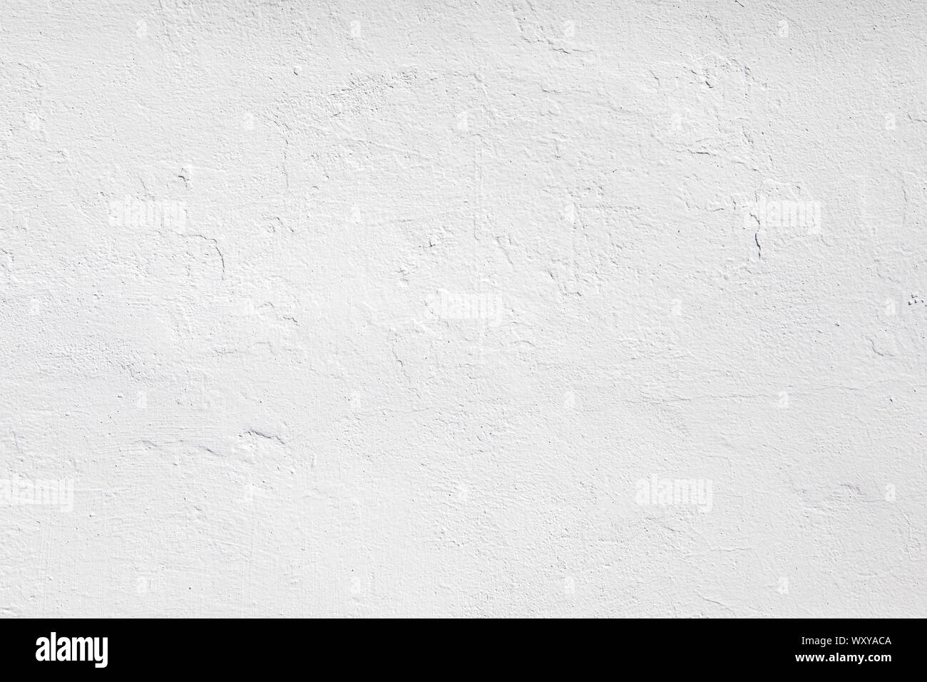 Neutral white colored low contrast Concrete textured background with roughness and irregularities to your concept or product. Stock Photo