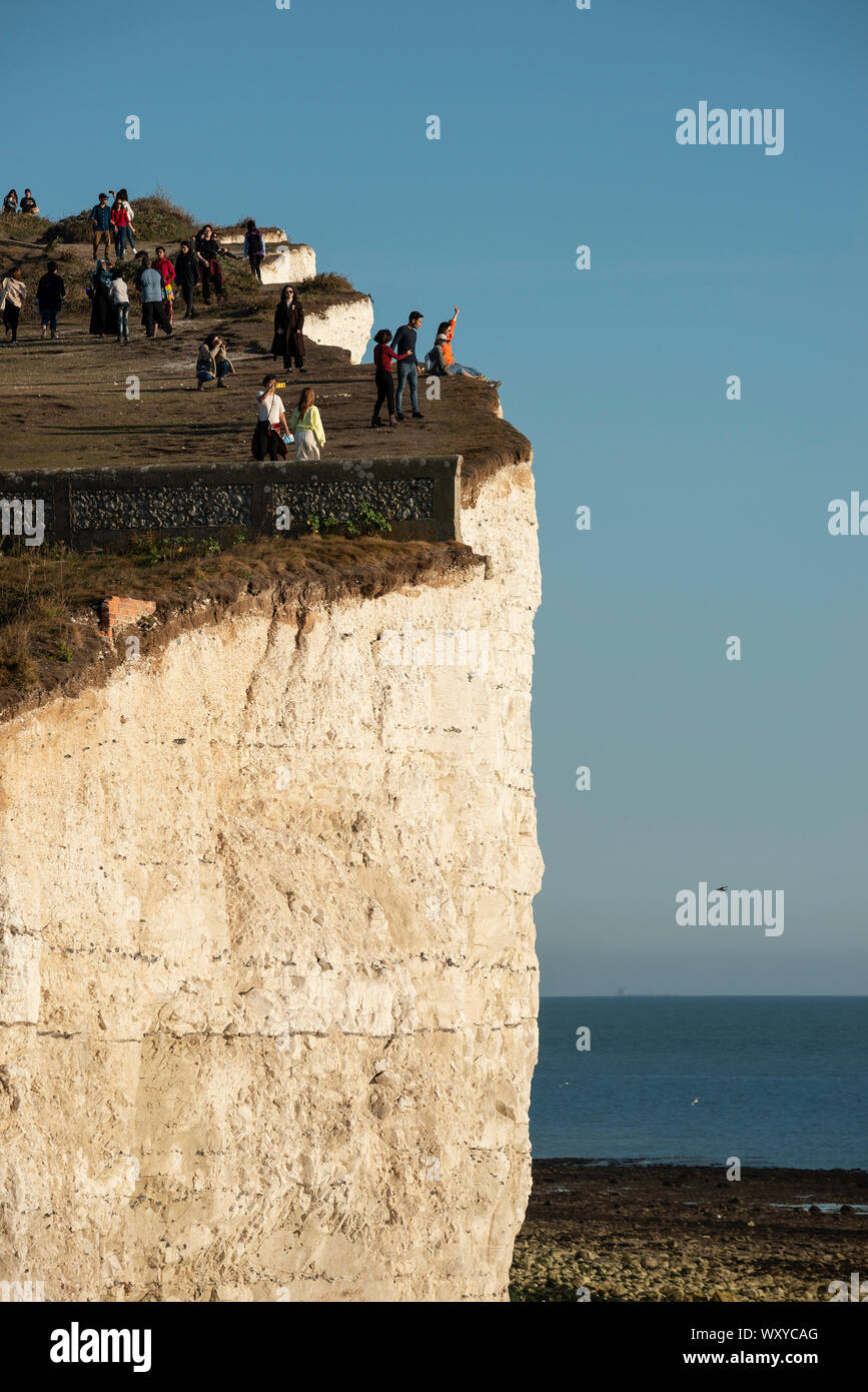 Tourists On Top Of Seven Sisters Chalk Cliffs Landscape In Sussex tourists-on-top-of-seven-sisters-chalk-cliffs-landscape-in-sussex