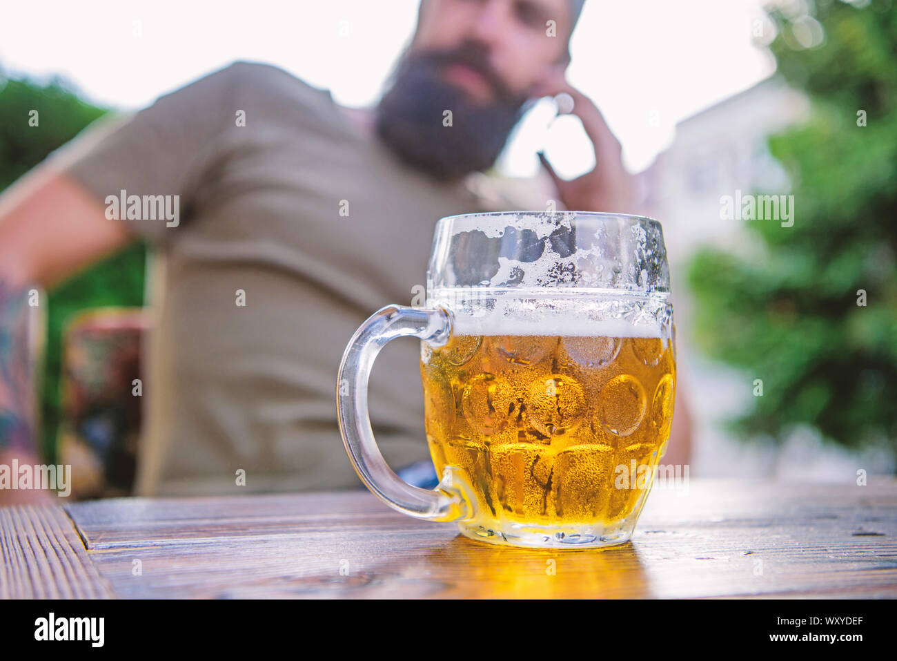Drinking from a mug to keep things firmly in hand. Beer mug. Serving
