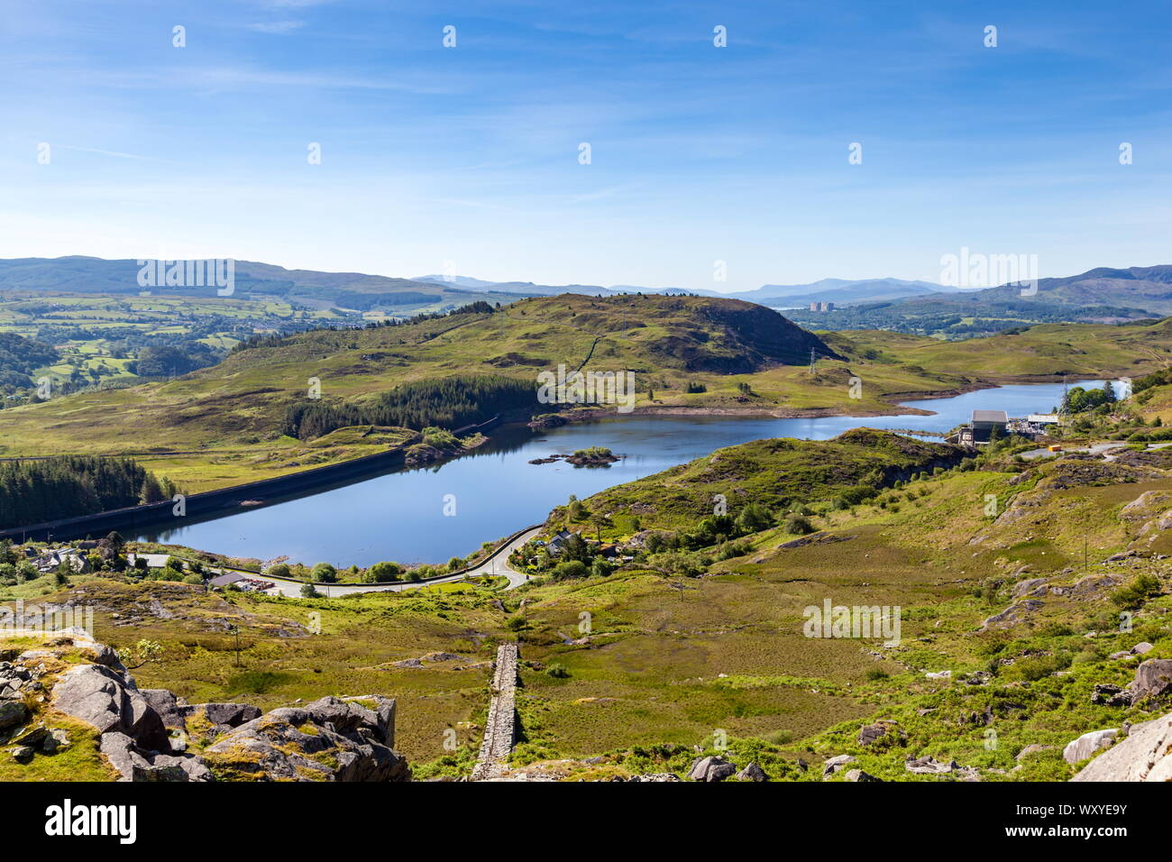 Tanygrisiau reservoir, the lower reservoir for the Ffestiniog hydroelectric power station. The now disused reactors of Trawsfyndd Nuclear power statio Stock Photo