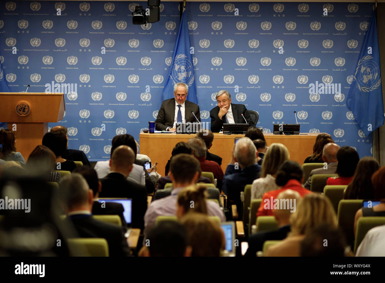 United Nations, UN headquarters in New York. 18th Sep, 2019. UN Secretary-General Antonio Guterres (R, rear) attends a press conference at the UN headquarters in New York, Sept. 18, 2019. The 74th session of the United Nations General Assembly (UNGA 74) will spotlight climate change in the coming days when leaders gather at the UN headquarters in New York to discuss issues of common concern, Antonio Guterres said Wednesday. Credit: Li Muzi/Xinhua/Alamy Live News Stock Photo