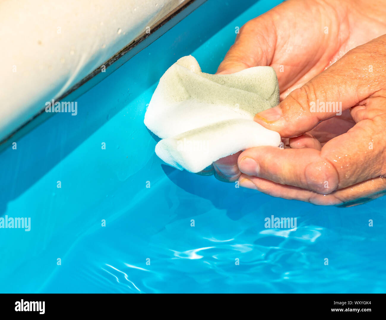 Clean the water line of a pool Stock Photo - Alamy