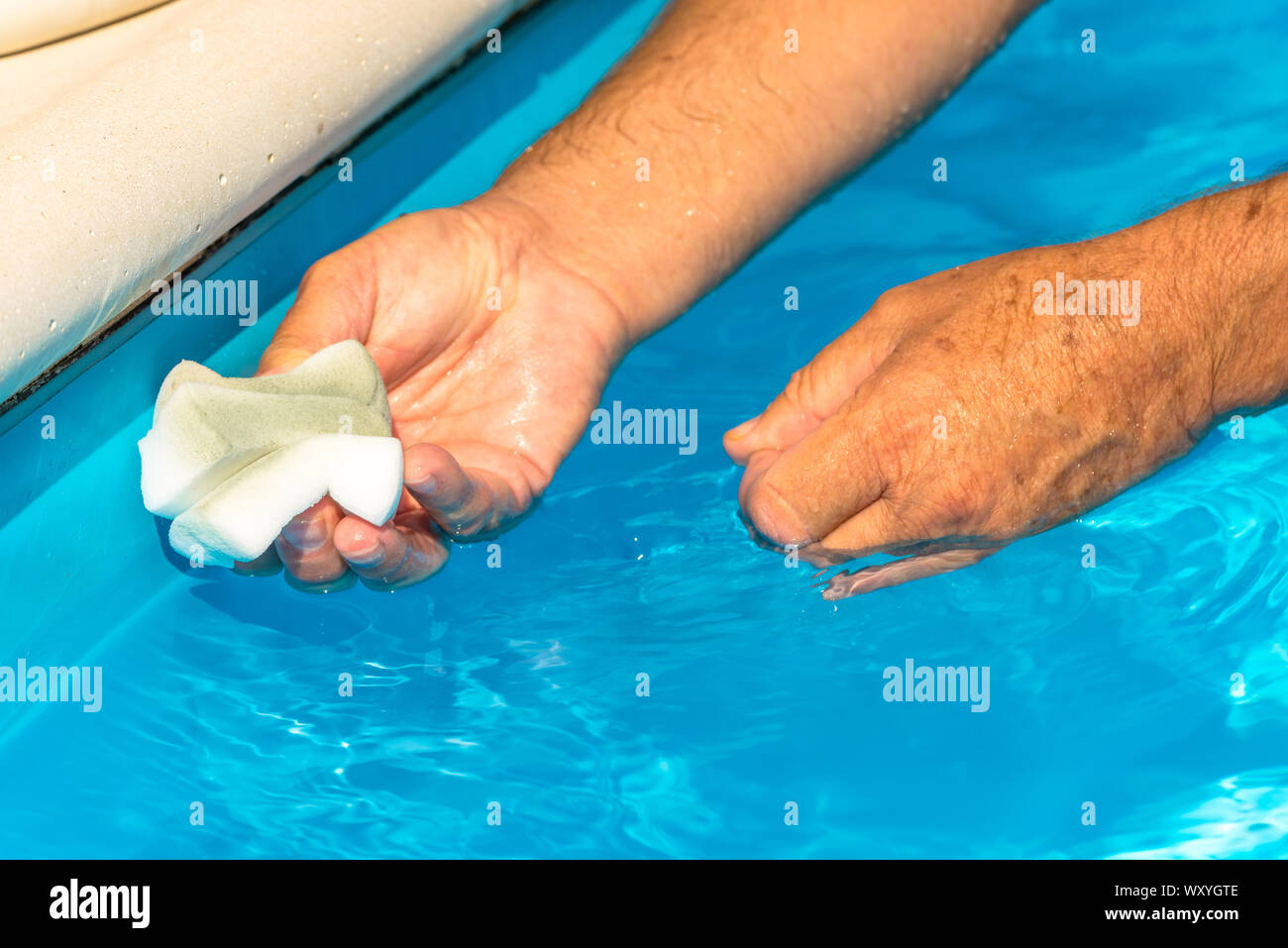 Clean the water line of a pool Stock Photo - Alamy