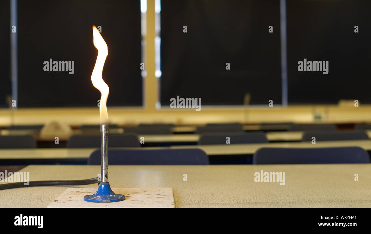 Gas burner with safety flame in a school science lab. Burning