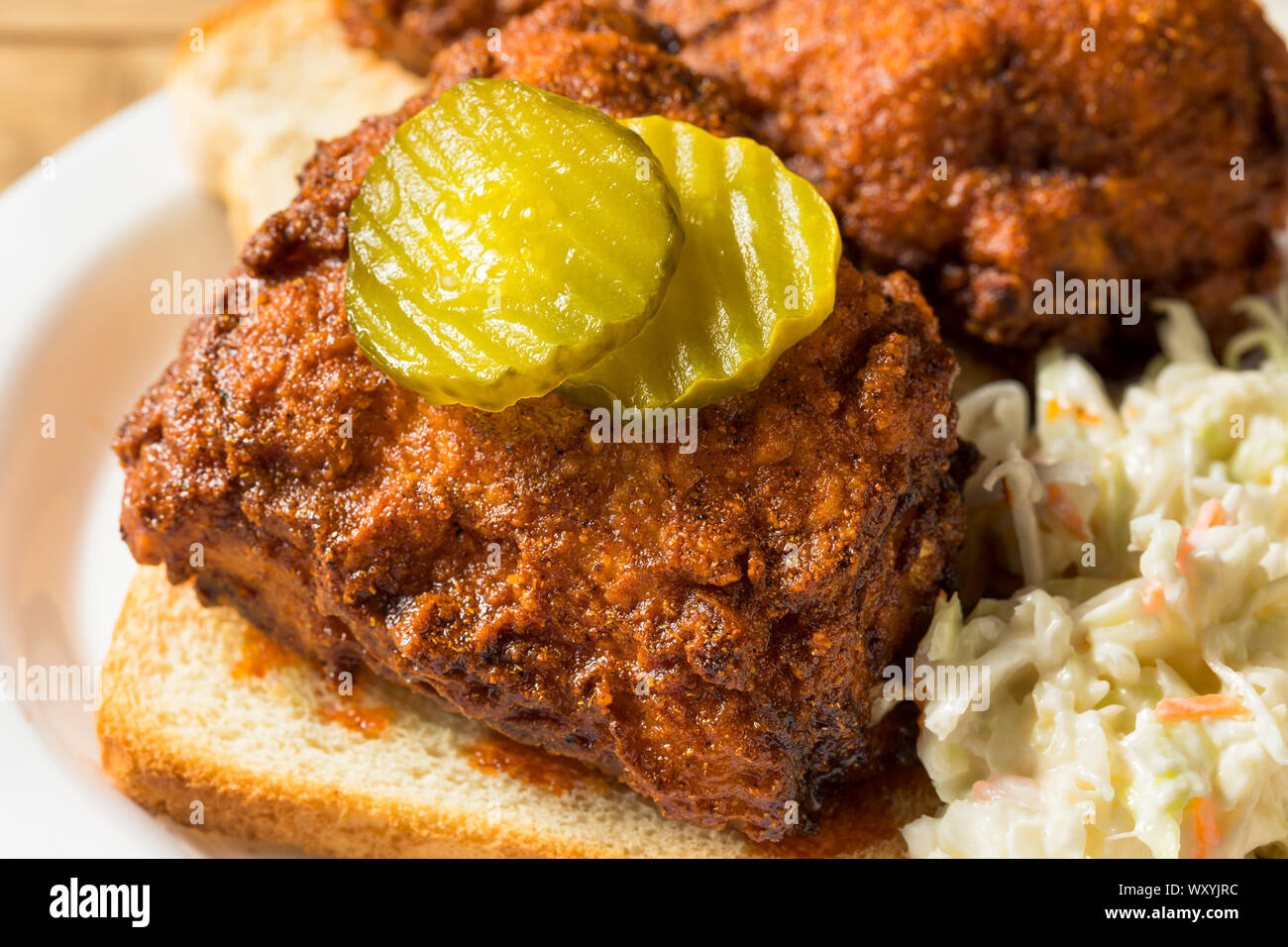 Homemade Nashville Hot Chicken with Bread and PIckles Stock Photo