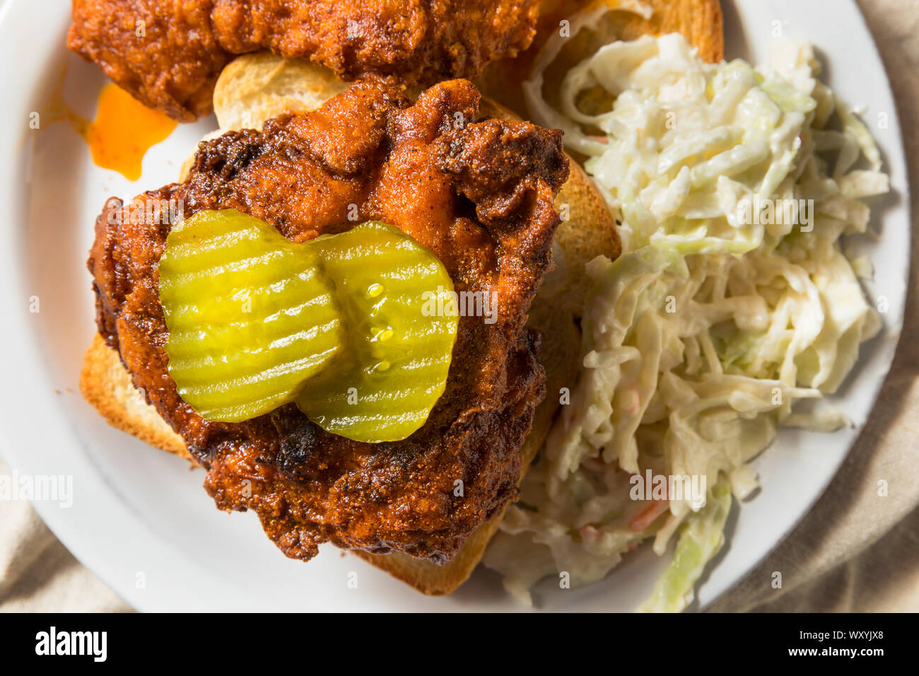 Homemade Nashville Hot Chicken with Bread and PIckles Stock Photo