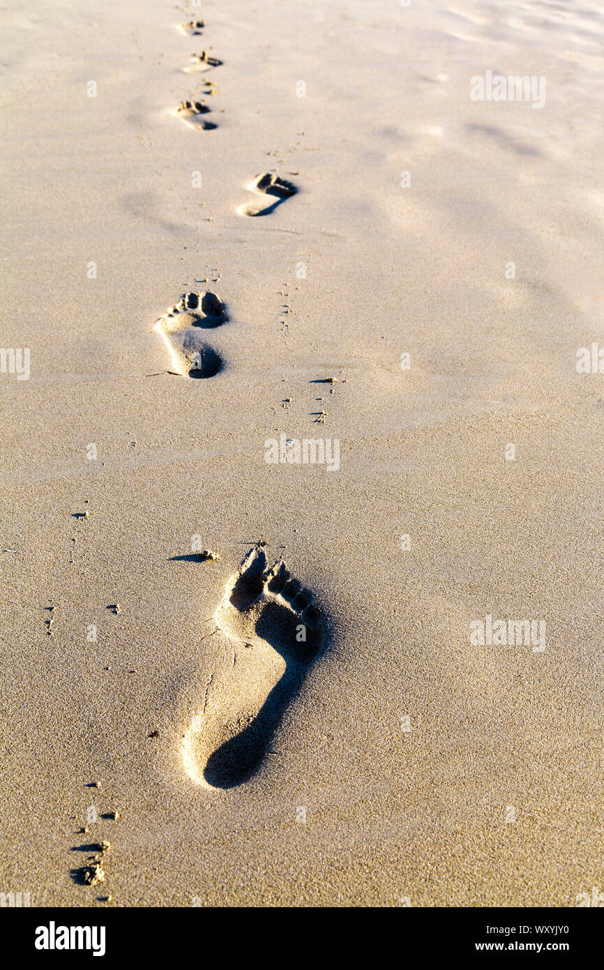 Footprints in the sand on a beach, Formentera, Spain Stock Photo