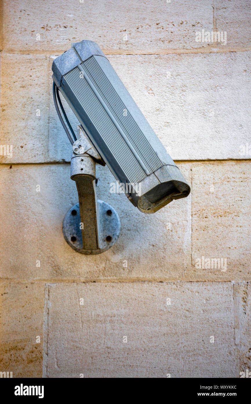 Close-up off old system CCTV camera mounted on a wall Stock Photo - Alamy