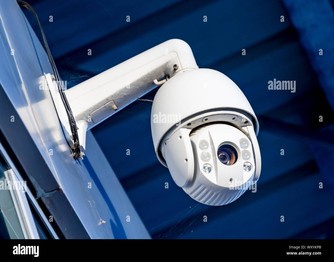 Closeup of modern CCTV camera on the wall of an industrial building