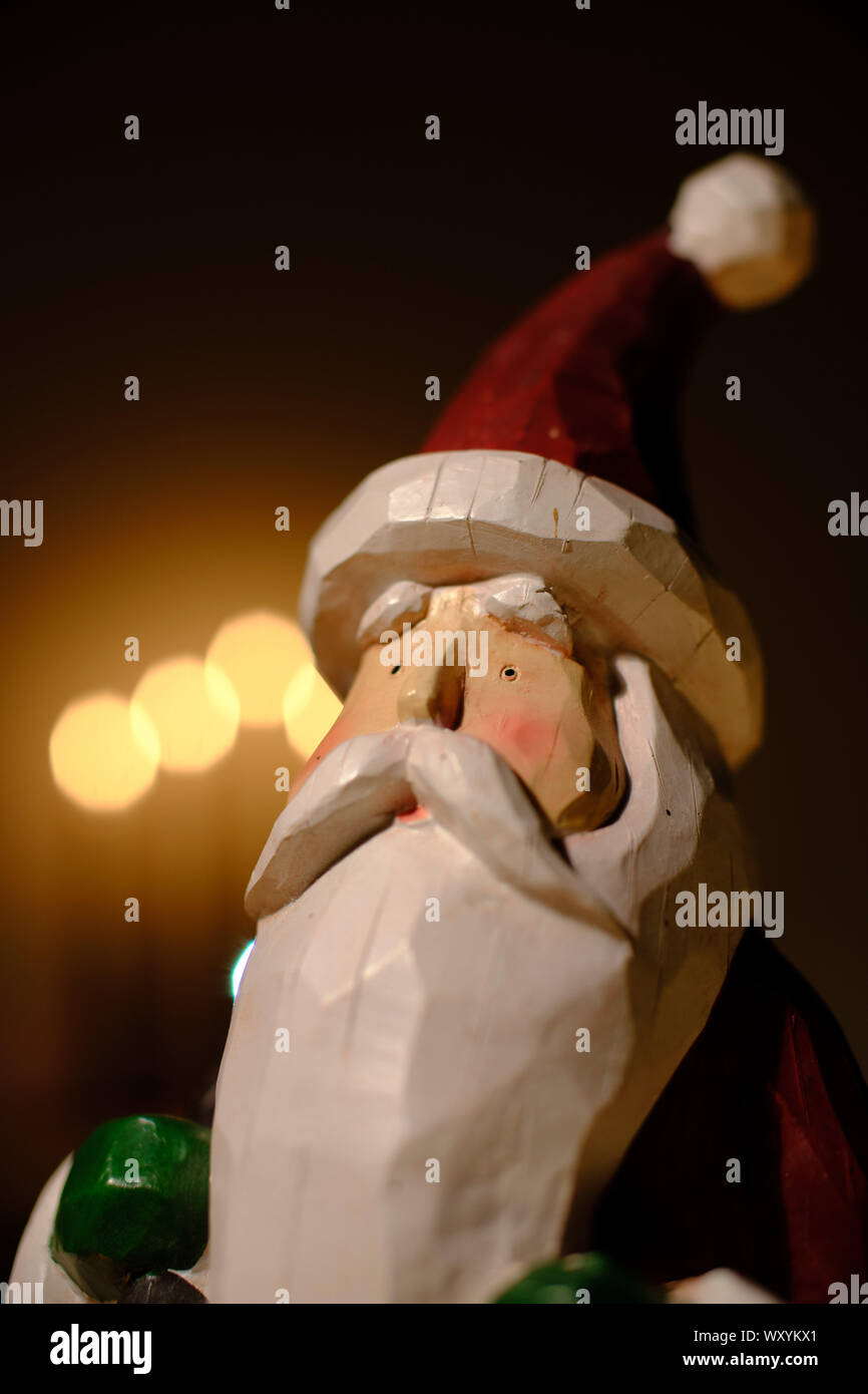 santa claus decoration in front of candle lights Stock Photo