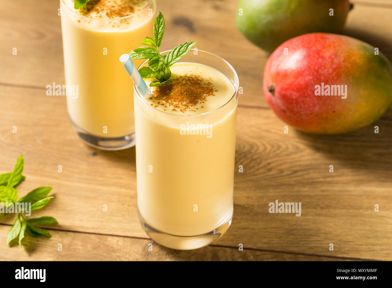 Homemade Sweet Indian Mango Lassi Smoothie with Mint Stock Photo - Alamy