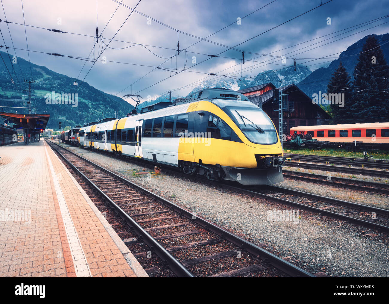 Beautiful high speed train on the railway station in mountains Stock Photo