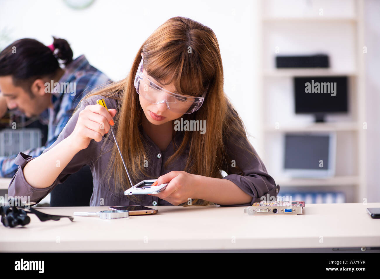 The two technicians working at computer warranty center Stock Photo