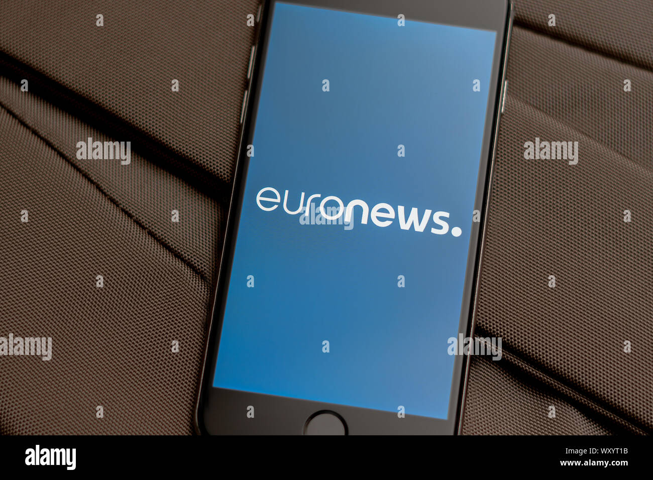 Black phone with logo of News media Euronews on the screen. News media icon. Canvas texture background. Illustration for marketing or business concept Stock Photo