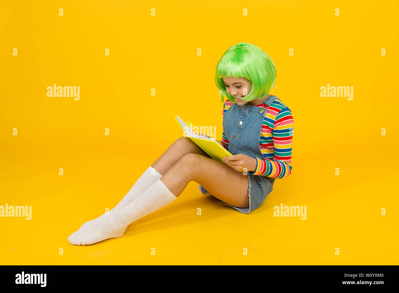 Geek girl reading comics magazine. Anime comics. Comics store. Anime fan.  Cheerful kid in bright colorful wig. Cosplay party concept. Happy childhood  concept. Hobby and interest. Reading literature Stock Photo - Alamy