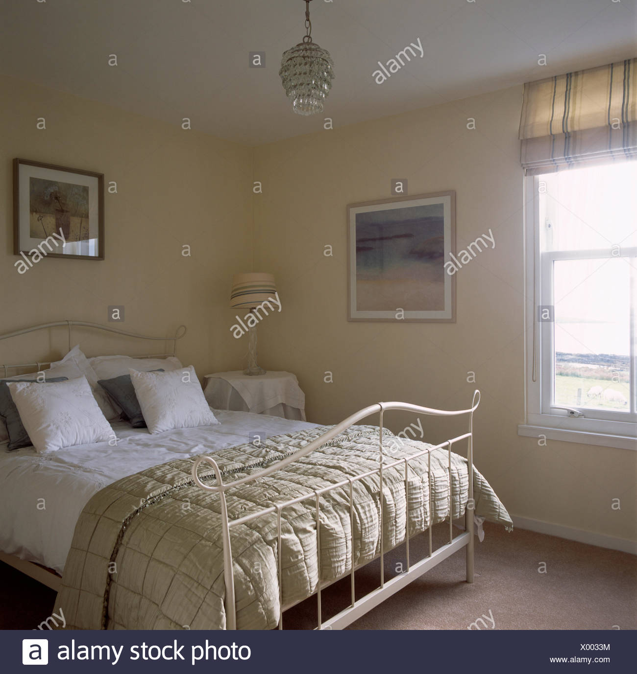 Beige Silk Quilt And White Bedlinen On Cream Metal Bed In