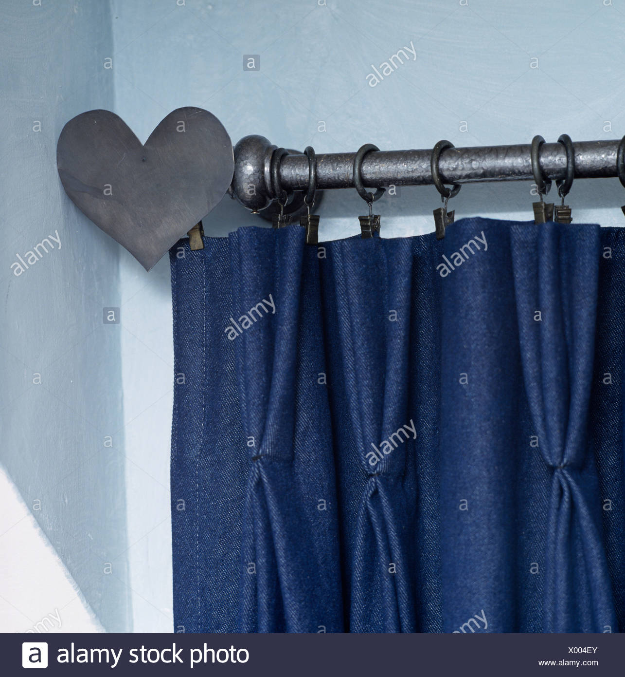 Close Up Of Pinch Pleated Dark Blue Curtain On Metal Curtain Pole