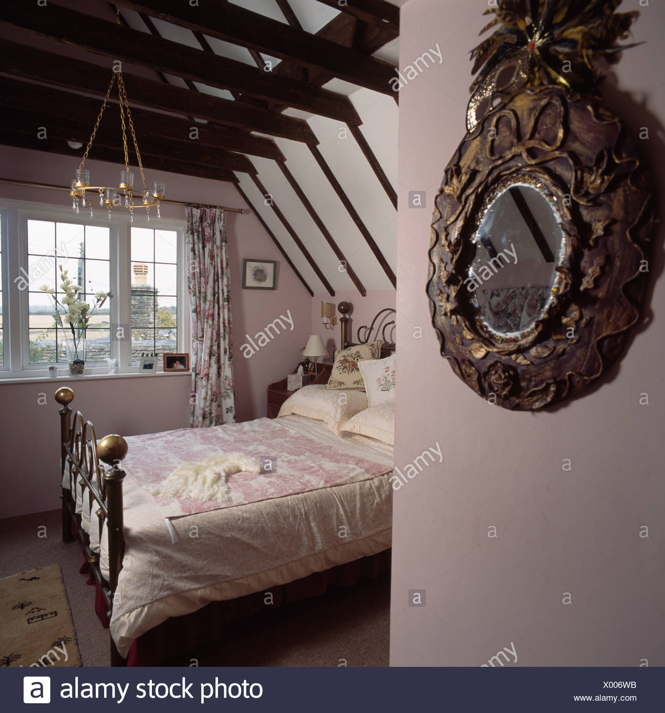 Ornate Antique Mirror And Brass Bed In Country Attic Bedroom