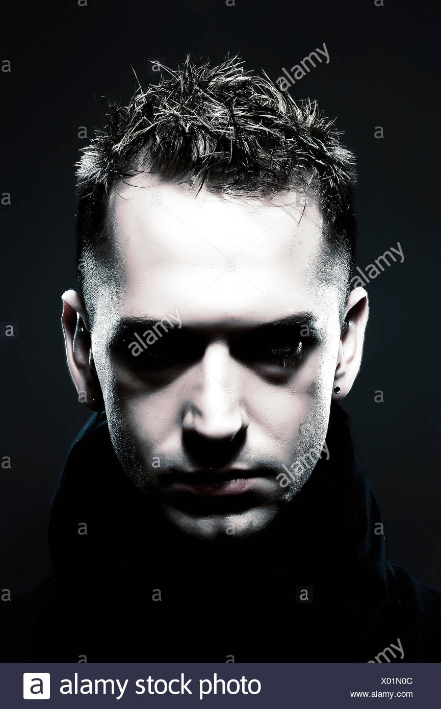 A Young Man Looks Down Toward His Feet His Hair Is Fixed With