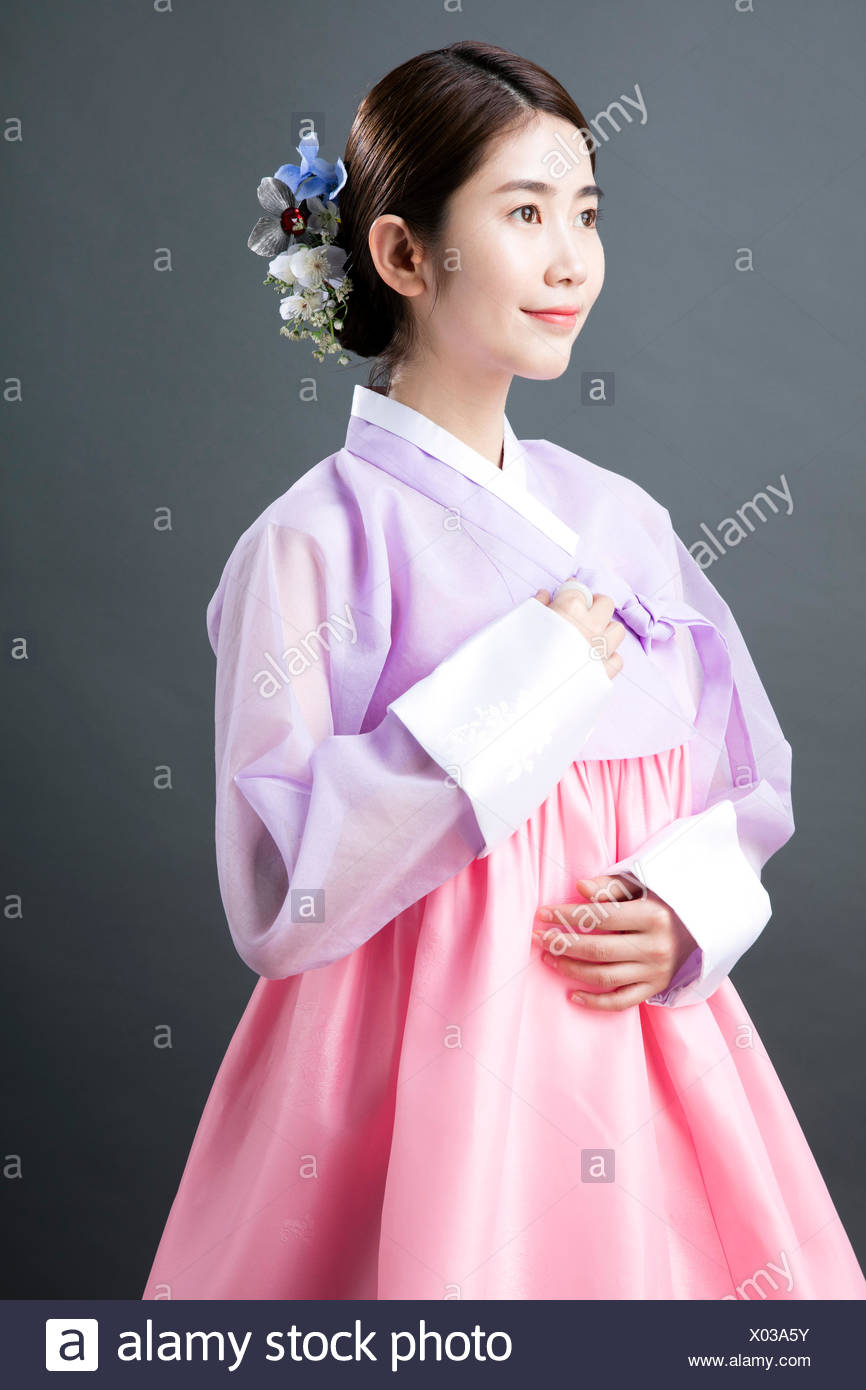 Side View Of Young Smiling Woman In Traditional Korean Clothes
