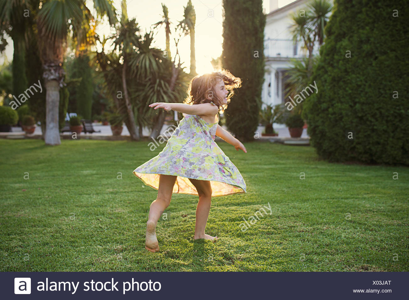 Girl spinning around in garden Stock Photo