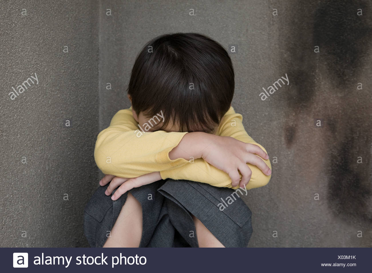 Young Child Sitting In Corner High Resolution Stock Photography and