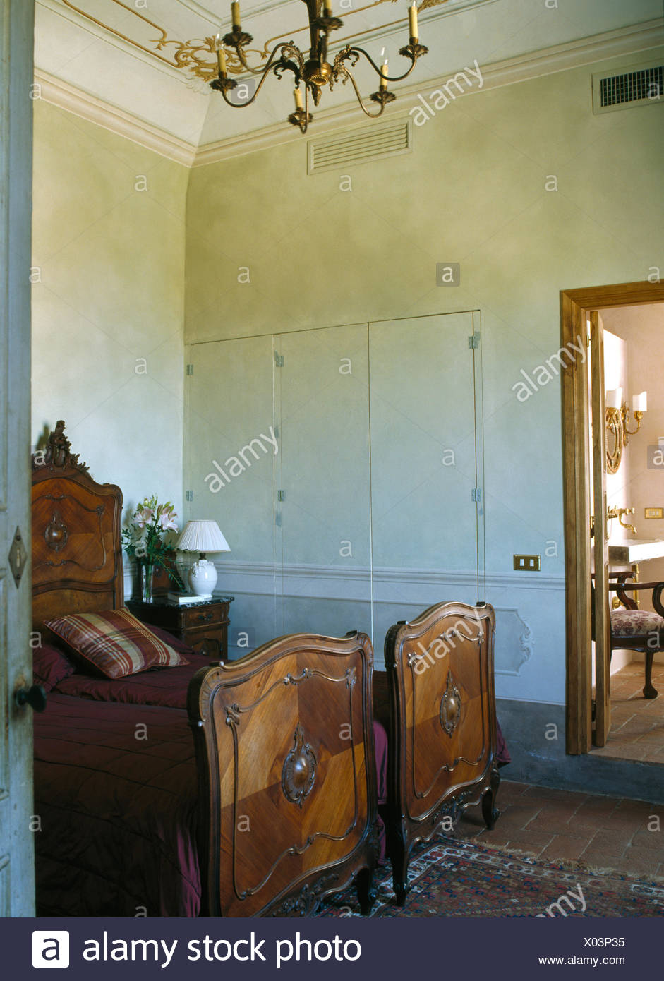 Antique Wooden Beds In Old Fashioned Tuscan Bedroom Stock