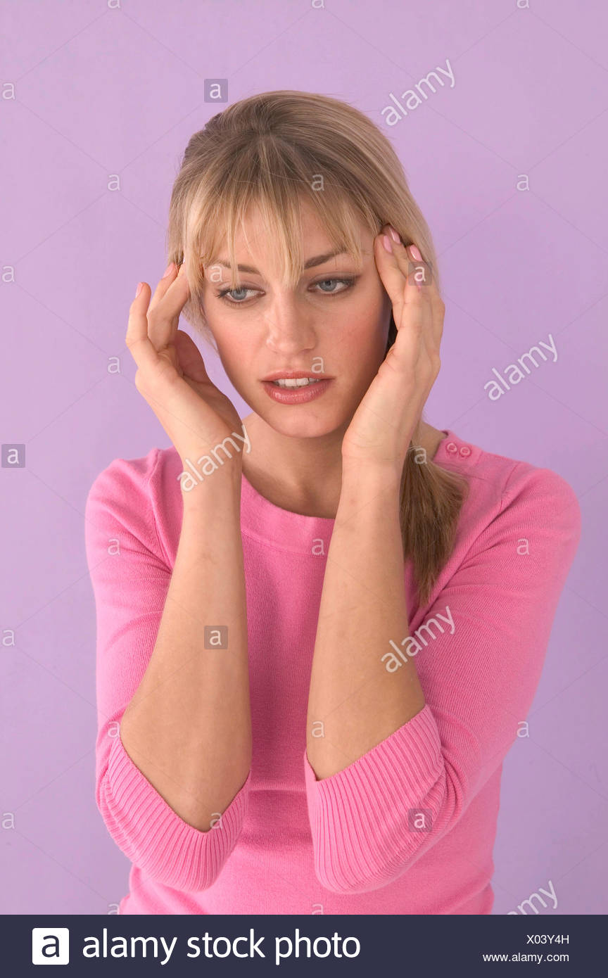 Female Blonde Hair And Fringe Wearing Pink Top Fingers To Temples