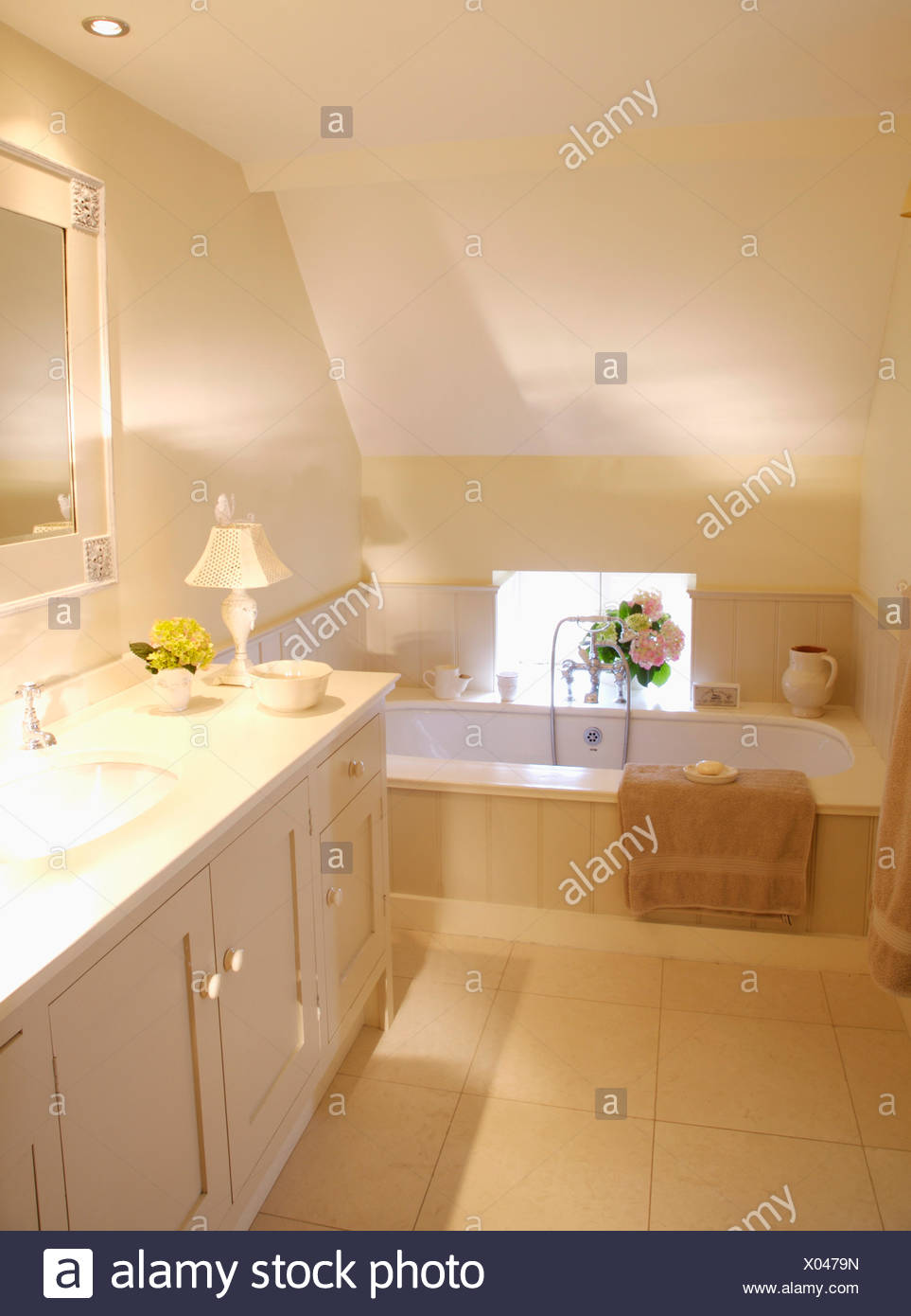 Cream Floor Tiles In Modern Attic Bathroom With Downlighting And