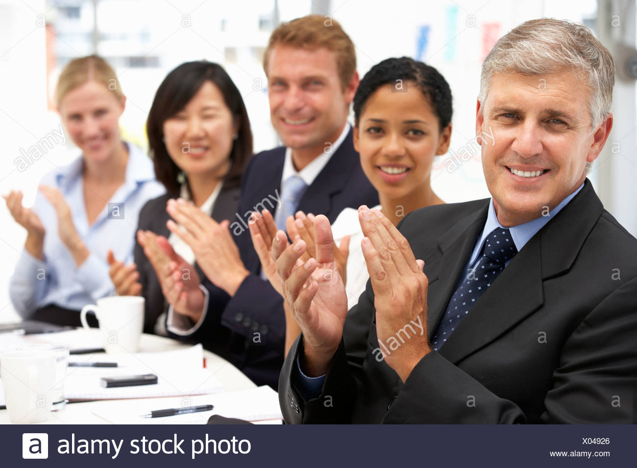 business people in row clapping stock photos business people in