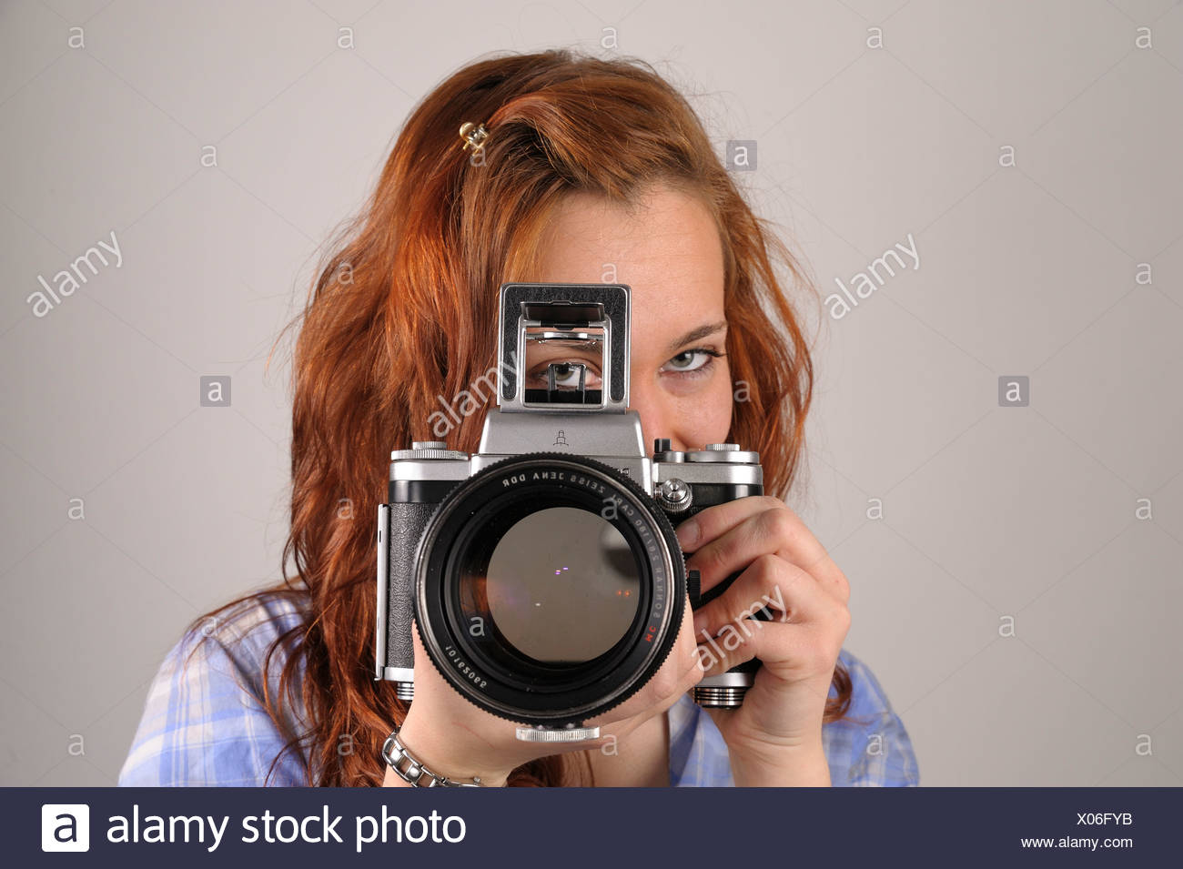 Young Woman With Red Hair Taking A Photograph With An Analog