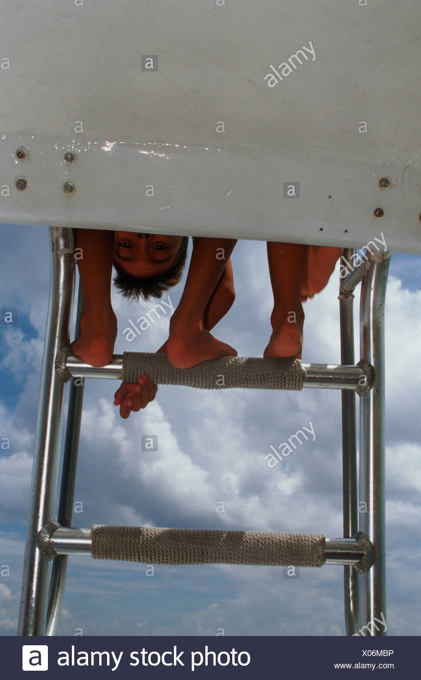 Two Pairs Of Legs Hanging From A Lifeguard Chair In Cozumel Mexico