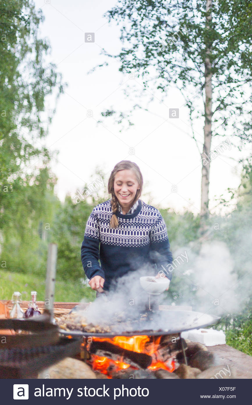 A Woman Cooking On A Fire Pit Stock Photo 275531467 Alamy