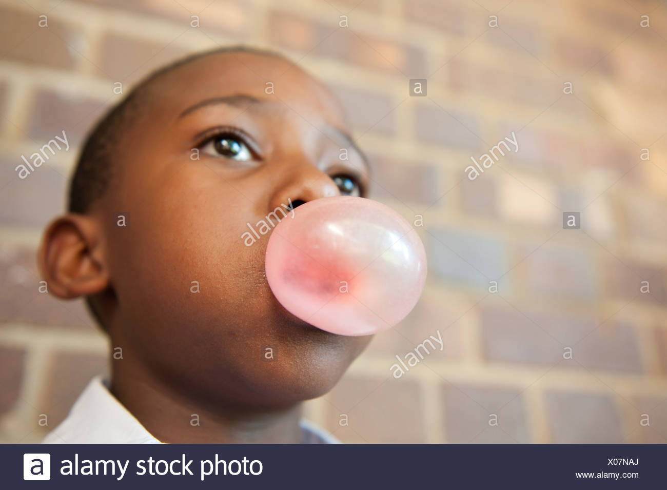 Boy blowing bubble with chewing gum, Johannesburg, Gauteng Province, South Africa Stock Photo