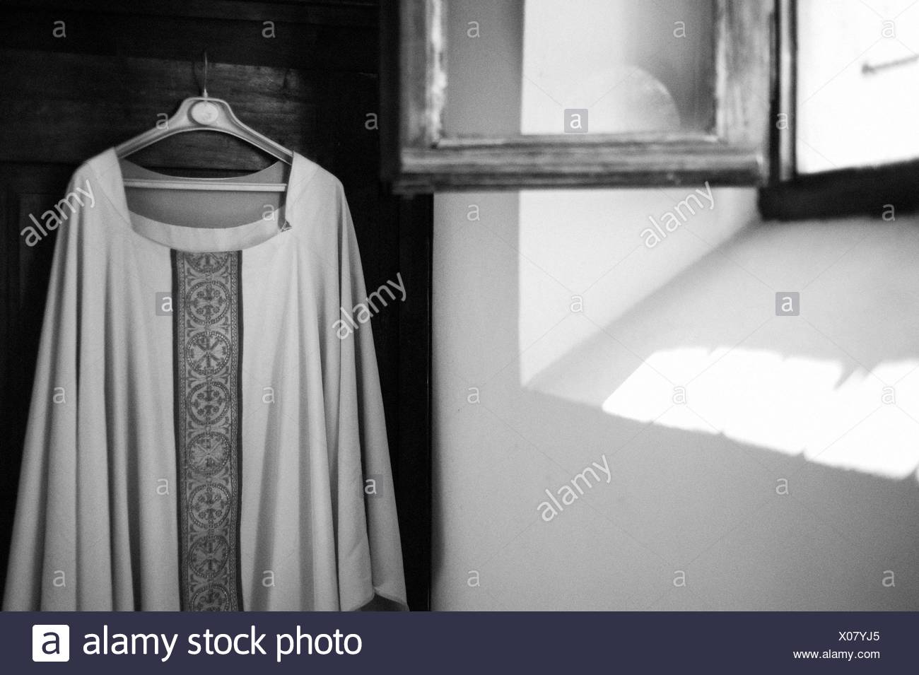 Sacristy Robe Of The Priest Hanging In Wardrobe Stock Photo