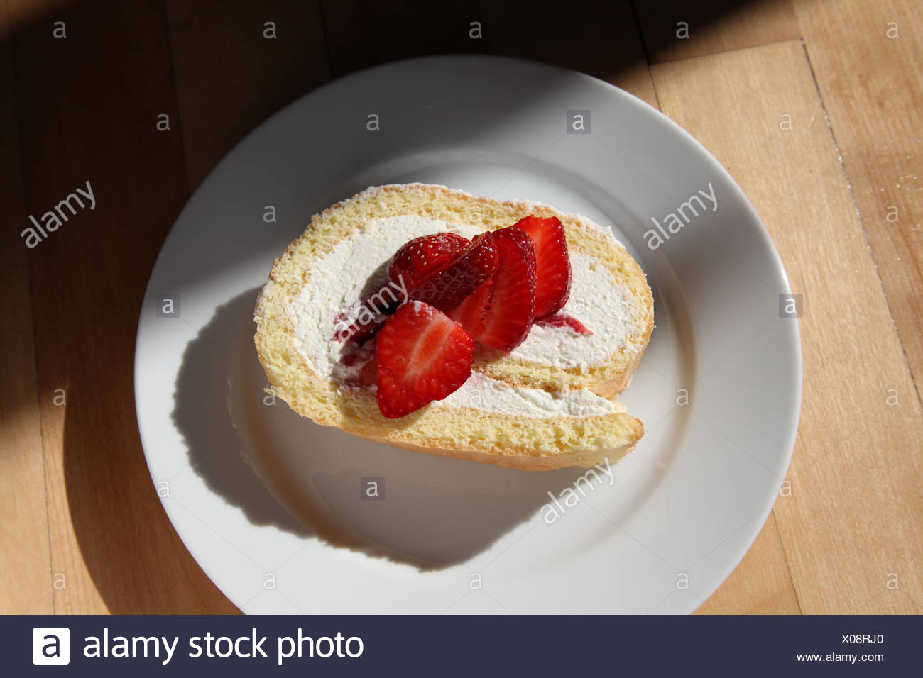 Fresh Sponge Cake Decorated Cream Roll On Cake Plate With